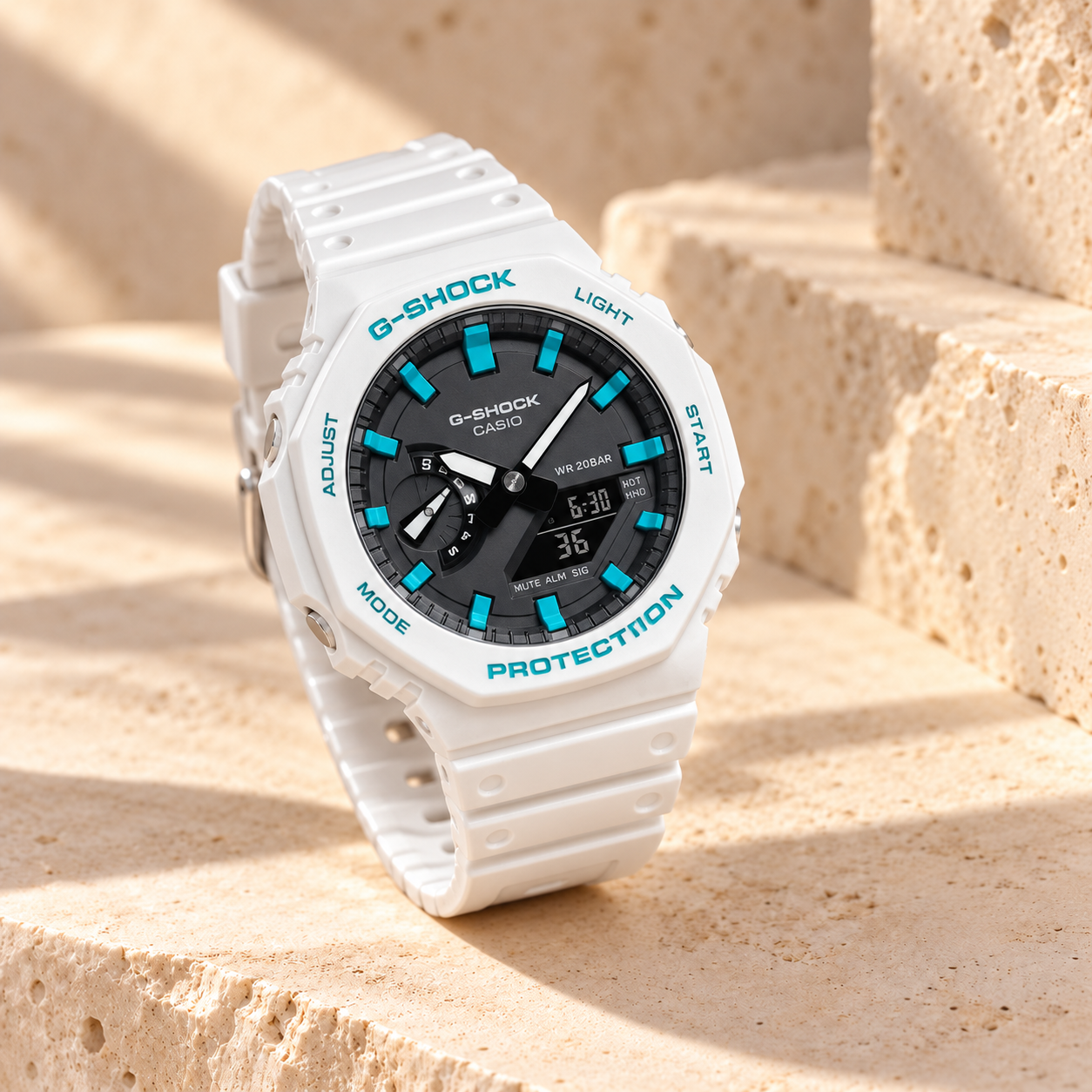 White and turquoise G-Shock CasiOak on a warm stone studio backdrop