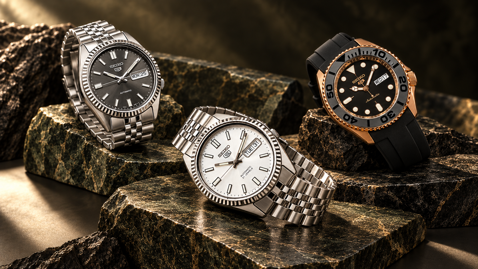 Three modified Seikos: silver and slate stainless-steel SNXS dress watches and a rose-gold-accent 5KX sport watch
