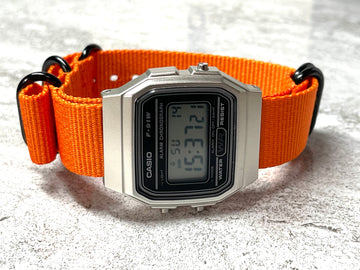 Casio F-91 Watch (Light Blue) on an Orange Nylon Strap